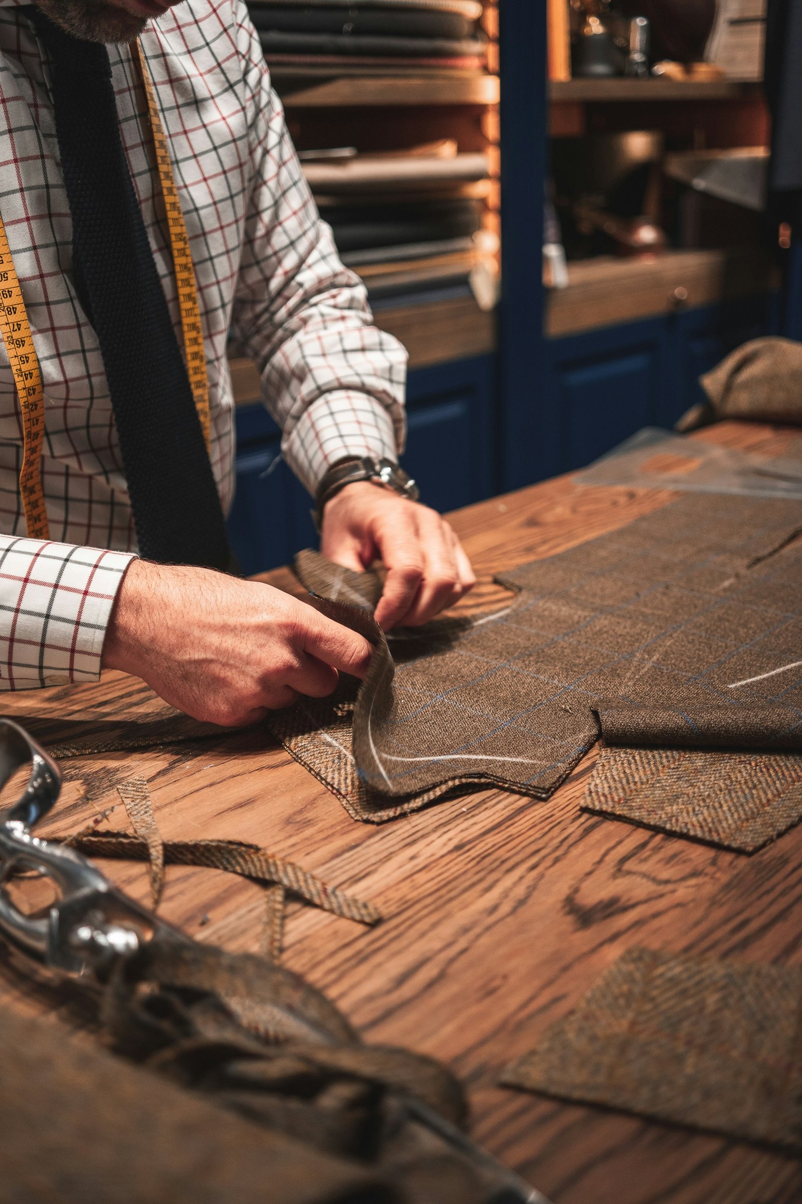 Royal Design's master tailor hand-finishing a jacket in the Ludhiana workshop