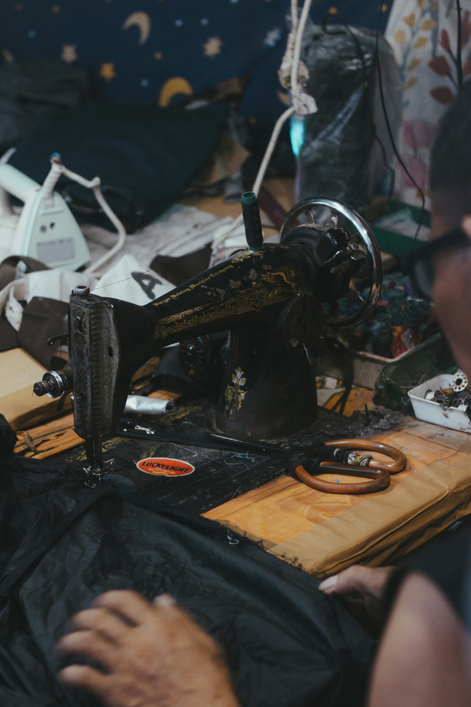 Tailor working on alterations at sewing machine