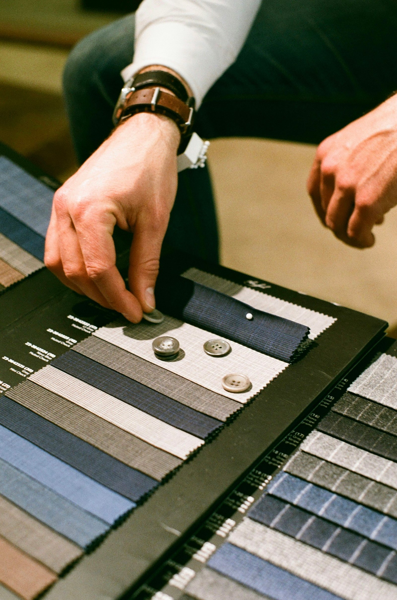 Tailor's hands working a piece of fine suiting fabric